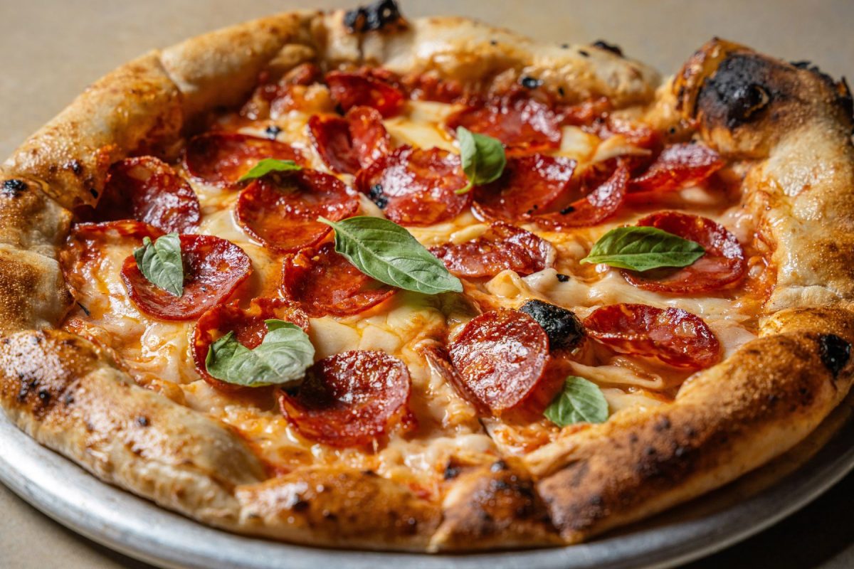 Pepperoni and sausage pizza with basil
